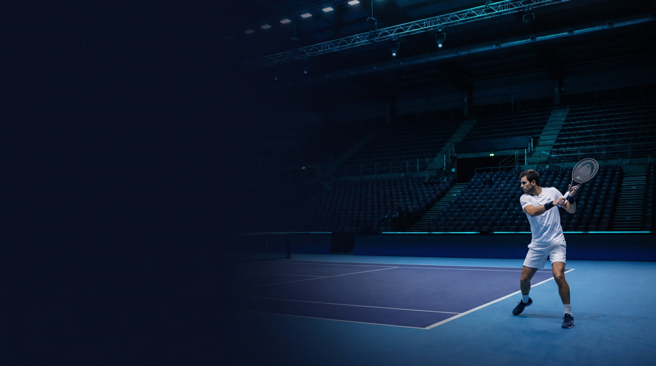 Inalpi Arena Turin at the Nitto ATP Finals during an evening session, indoor purple-blue hard court vivid under suspended truss lighting, signature deep navy and indigo arena atmosphere with cyan stage lighting accents and rows of seating receding into shadow